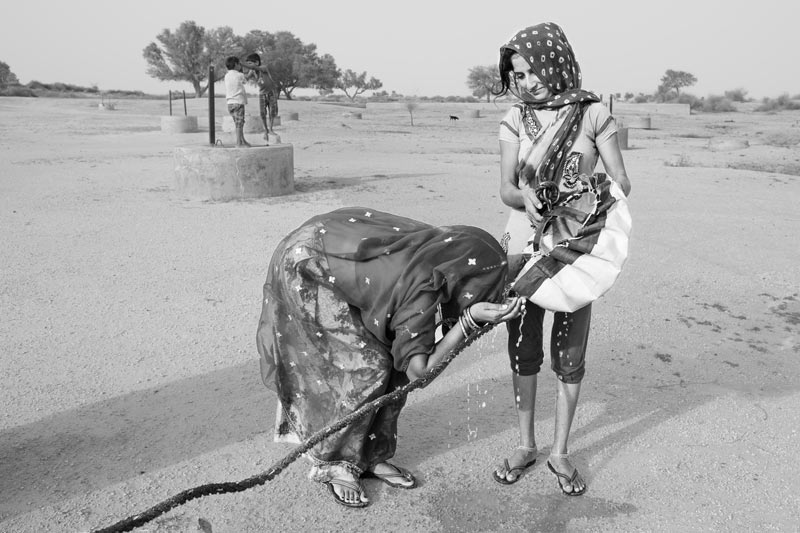 Quenching the thirst at a 'kuin' (shallow well) on a sunny morning - village Binjharwali, Bikaner district, Rajasthan